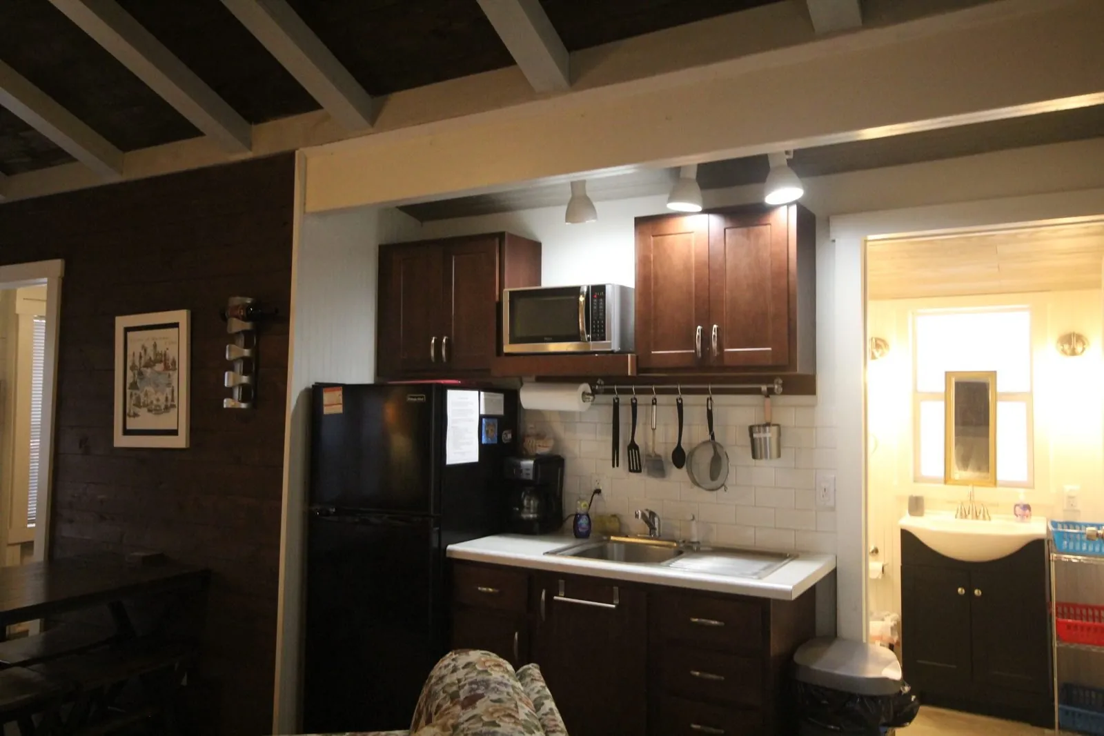 Dorothy Cottage kitchen with dark cabinets and a vanity area
