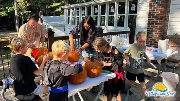 Kids carving pumpkins during Halloween weekend at the campground