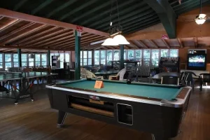 Inside the Lodge with a pool table and lake-view windows