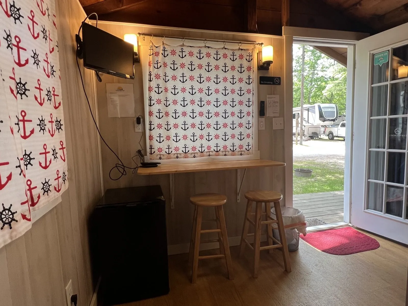 Mayor Cabin interior with nautical curtains and a small counter