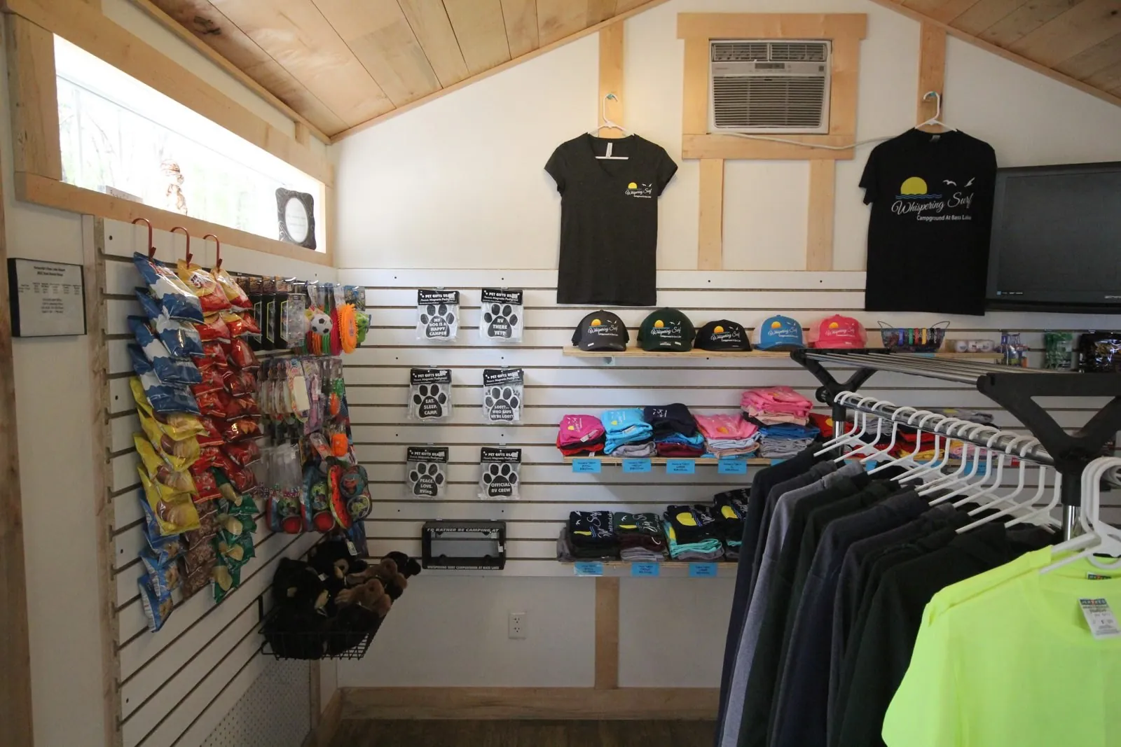 Camp store shelves with branded apparel and camping supplies
